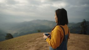 Pretty young asian female Photographer taking pictures outdoors during hiking.Freedom,independence,liberty,autonomy and deliverance concept.Young adult asian woman traveling take a photo with camera.