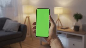 Handheld Camera: Point of View of Man at Phone with Green Screen for Copy Space. Chromakey Mock Up Without Tracking Markers. Close Up. Boy is Surfing Content With Touching Swiping Up and Tap Center. - Powered by Shutterstock - Get 15% off with code: PIKWIZARD15