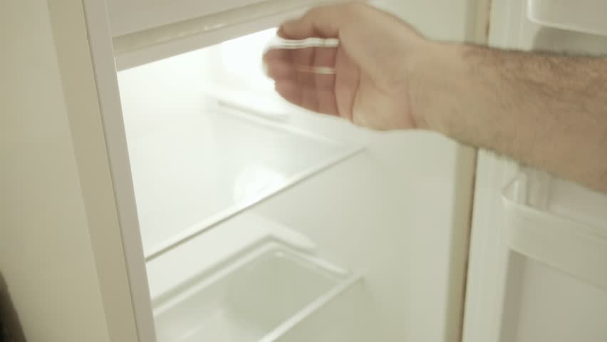 The hand of a man opening a vintage fridge, discovering that it's completely empty, showing disappointment. Angled closeup shot.
 | Shutterstock HD Video #1098863279