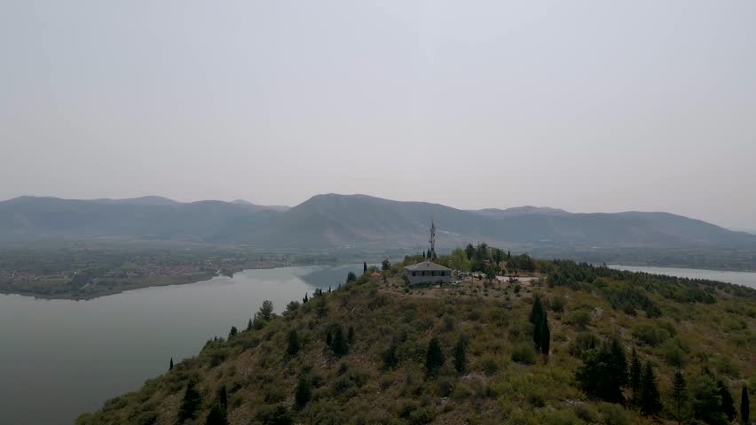 Aerial clip over a mouintain revealing the city and lake of Kastoria, in northern Greece
