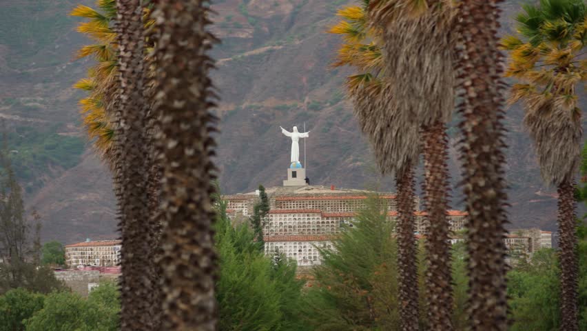 Statue of Christ in a cemetery in the city of Yungay under Mount Huascaran in Peru