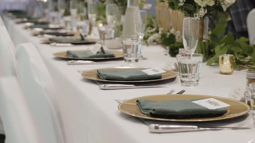Elegant wedding dining table silverware arrangement on a long horizontal table | Shutterstock HD Video #1098881057