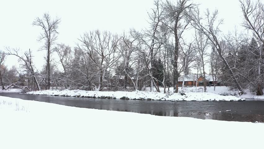 Boise River in Idaho with snow covering the ground around it.