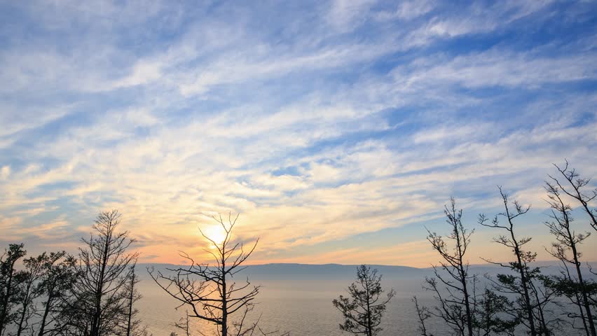 Russia, Lake Baikal. Sunset over Lake Baikal. Small Sea Bay, view from Olkhon Island, TimeLapse