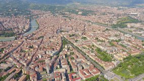 Inscription on video. Verona, Italy. Flying over the historic city center. Roofs of houses, summer. Shimmers in colors purple, Aerial View
