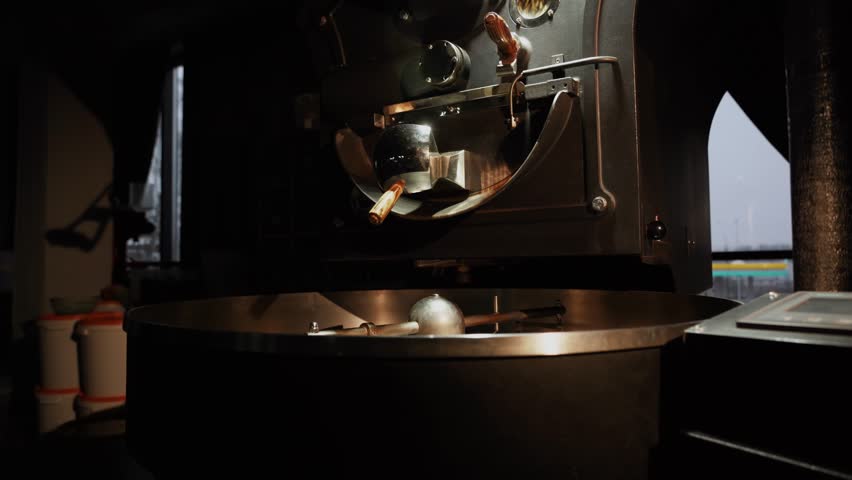 Roasted coffee beans after roasting are mixed on the cooling plate of the oven. Industrial bean roasting. Coffee production process Royalty-Free Stock Footage #1098890241