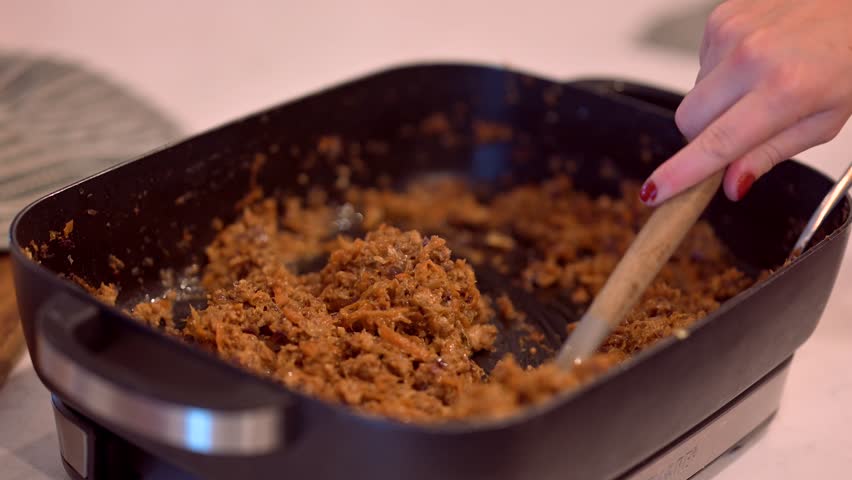 A woman making an eggroll burritos
