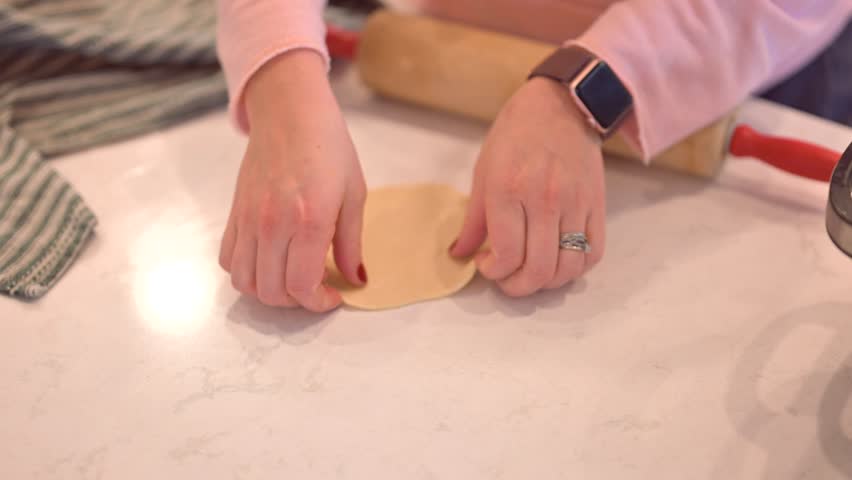 A woman making an eggroll burritos