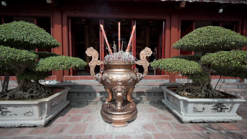A closeup of incense burning at the altars in Ngoc Son Buddhist Temple in Hanoi, Vietnam