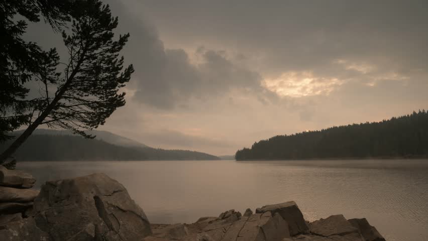 Fog over lake, early in the morning.