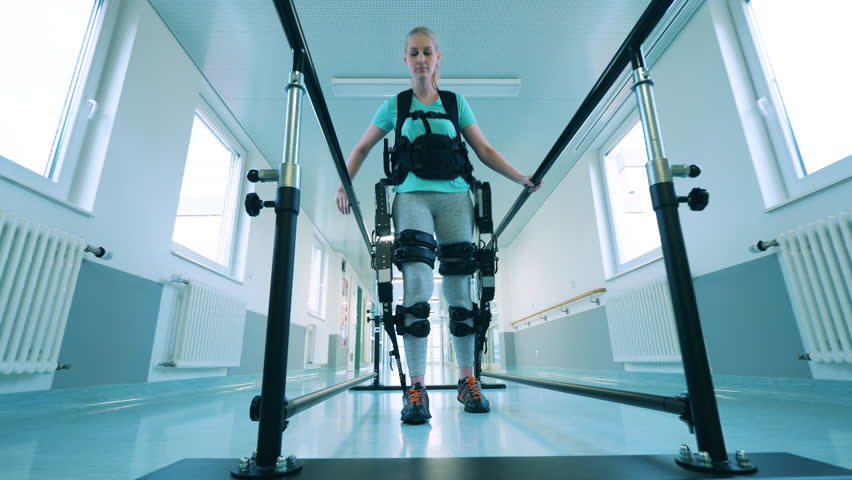 A woman with physical disability is walking in the exoskeleton Royalty-Free Stock Footage #1098897627