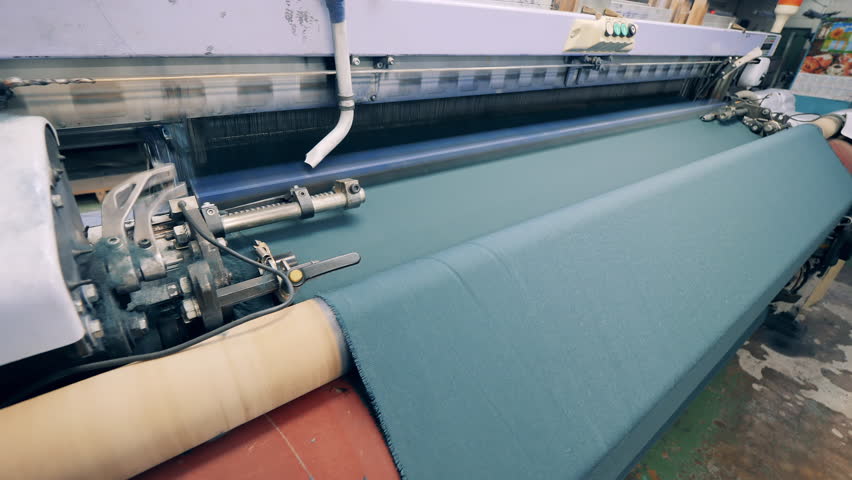 Woven fabric is getting released by an industrial machine Royalty-Free Stock Footage #1098897767