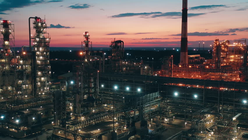 Oil refinery factory with electric lights filmed at sunset Royalty-Free Stock Footage #1098897777