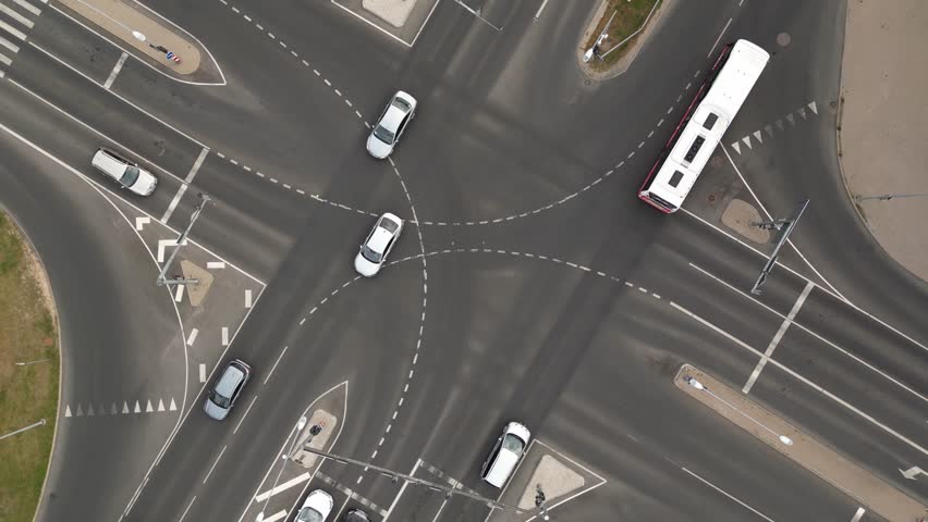 Top down aerial of cars drive at cross road. Car traffic and people crossing road. Traffic highway transportation. Crowded people walk, pedestrians crossing busy intersection. Skyscrapers buildings | Shutterstock HD Video #1098901497