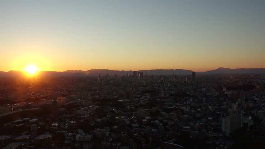NAGOYA, JAPAN - OCTOBER 2022 : Aerial high angle view of NAGOYA CITY in sunset or sunrise. View of buildings and street traffic around Nagoya station and Sakae area (central downtown).