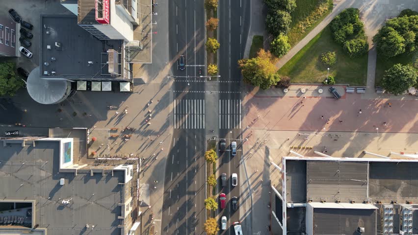 Top down aerial of cars drive at cross road. Car traffic and people crossing road. Traffic highway transportation. Crowded people walk, pedestrians crossing busy intersection. Skyscrapers buildings | Shutterstock HD Video #1098905129