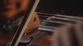 Playing with a bow on the violin, macro video