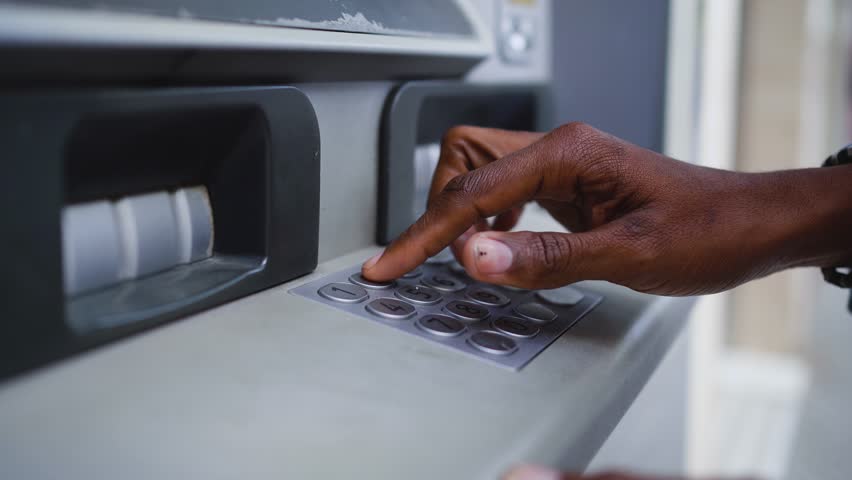 Close up shot of a man typing his PIN code on a keyboard of a ATM to withdrawal money from bank Royalty-Free Stock Footage #1098912517