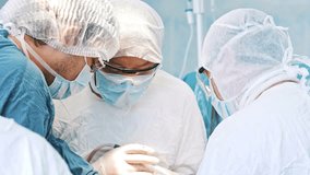 Multi-ethnic cooperating team of doctors and surgeons processing surgical operation in operating room modern hospital emergency department. Heart surgery. Concept of medicine, medicare and healthcare. - Powered by Shutterstock - Get 15% off with code: PIKWIZARD15