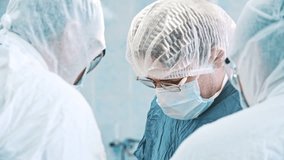 Multi-ethnic cooperating team of doctors and surgeons processing surgical operation in operating room modern hospital emergency department. Heart surgery. Concept of medicine, medicare and healthcare. - Powered by Shutterstock - Get 15% off with code: PIKWIZARD15