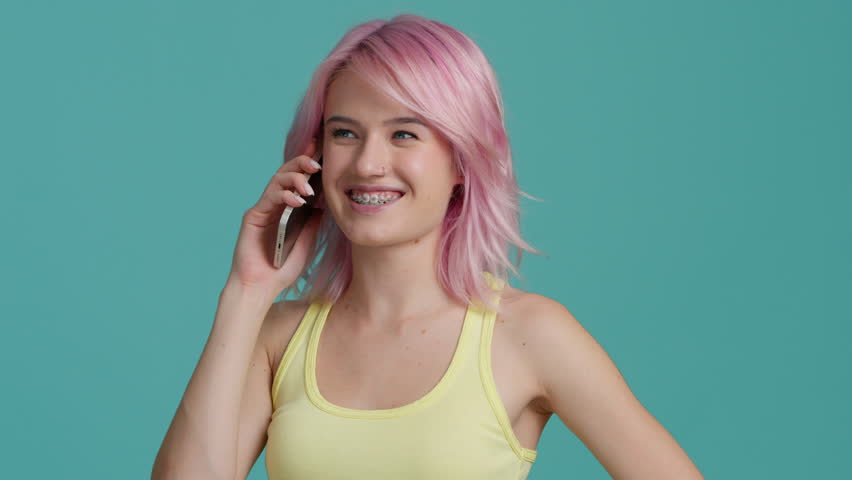 Smiling young business woman professional talking phone. Happy female entrepreneur with beautiful pastel pink hair make mobile call confirming online website order. Customer shopping delivery concept Royalty-Free Stock Footage #1098916609