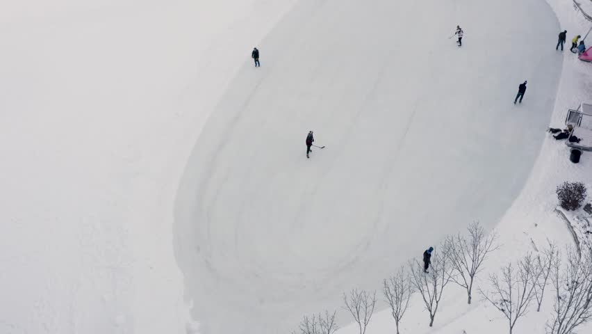 Aerial shot of people playing hockey on public ice at the forks in Winnipeg Manitoba.