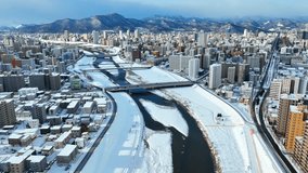 Sapporo in winter, city in Hokkaido, Japan, aerial view of snowy cityscape of Sapporo, tourism in northern Japan. High quality 4k footage