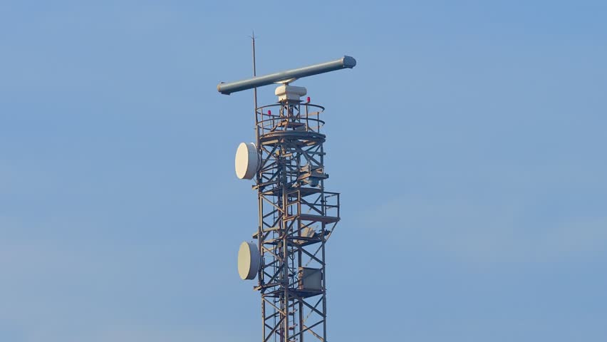 Radar Tower Beacon against a blue sky on a sunny day. Metal truss construction. | Shutterstock HD Video #1098928197