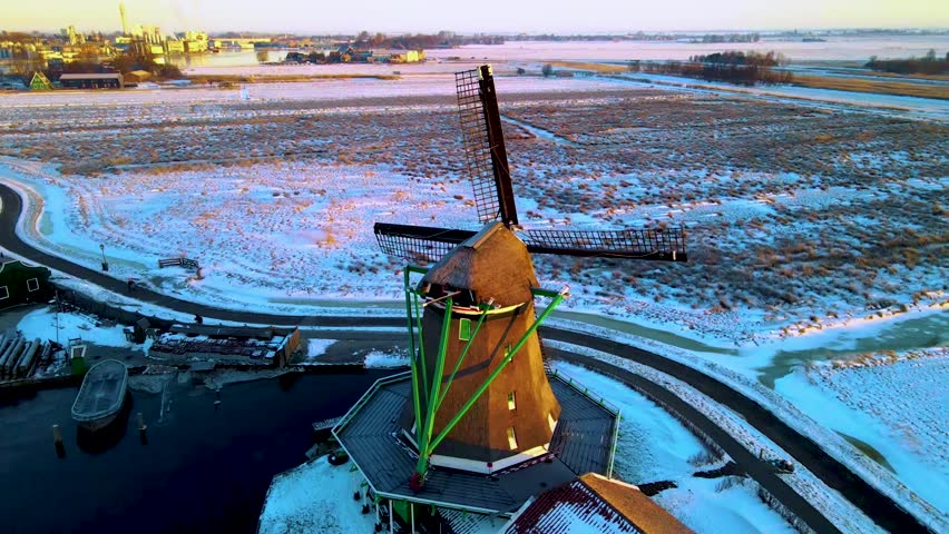 snow covered windmill village in the Zaanse Schans Netherlands, historical wooden windmills in winter Zaanse Schans Holland during winter. 