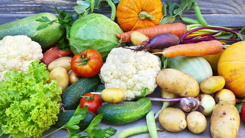 Freshly picked raw vitamin vegetables on a wooden background. Rustic still life. Organic healthy natural food. Close-up, mock up | Shutterstock HD Video #1098930969
