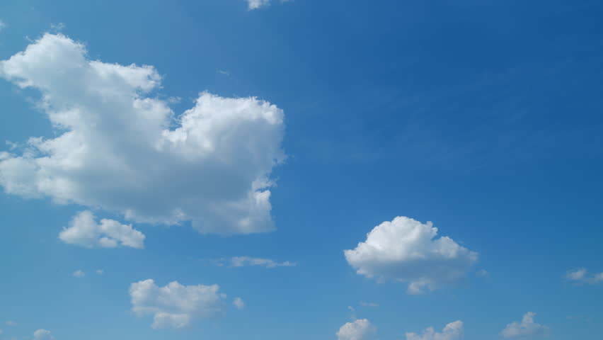 Puffy fluffy white clouds. Forming cloud moving with blue sunny, summer skies. Timelapse.