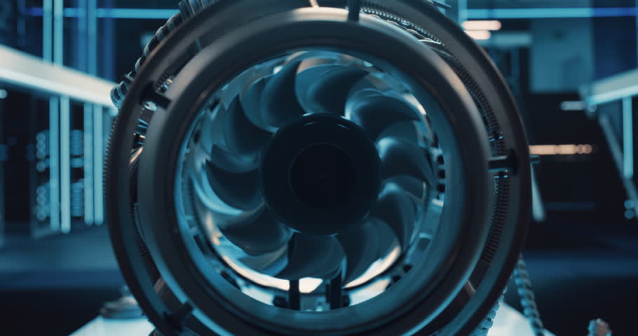 Industrial High Tech Sustainable Electric Turbine Motor in a Factory Workshop. Tech Facility with Servers, Computers and Research Equipment. Zoom Out Footage From Inside the Engine with Spinning Fan