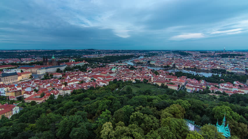 Wonderful day to night transition timelapse panoramic view to The City Of Prague From Petrin Observation Tower In Czech Republic after sunset. Coudy sky at summer evening