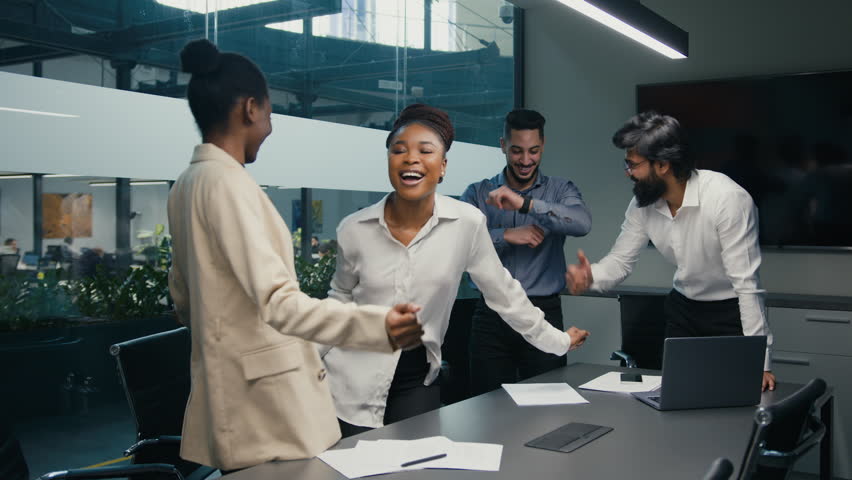 Motivated happy dancing multiracial diverse business group team company colleagues coworkers celebrating success in office with funny dance winning Friday day off celebrate having fun party together | Shutterstock HD Video #1098938549