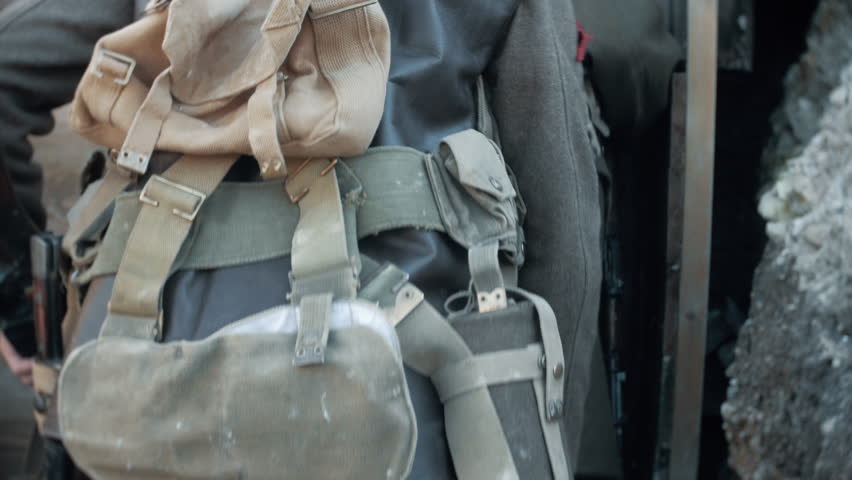 First wold war soldiers walking into a dug out in a ww1 trench.
