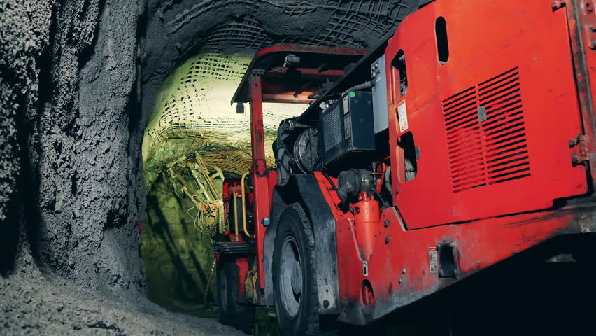 Massive boring machine working in the underground mine. Underground development, underground extraction, underground mining operations. Royalty-Free Stock Footage #1098940021