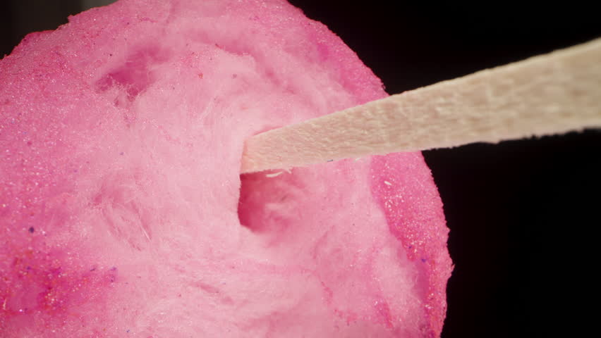 Pink sweet cotton candy on a stick is torn apart by hands. extreme close-up | Shutterstock HD Video #1098940525