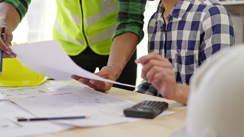 Close up of hands working brainstorming and measuring for cost estimating on paperworks and floor plan drawings about design architectural and engineering for houses and buildings. Royalty-Free Stock Footage #1098943515
