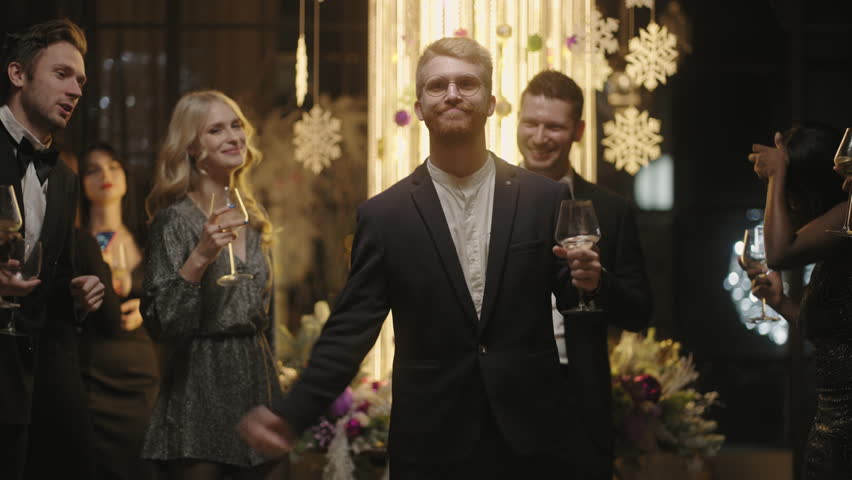 young people have fun in merry Christmas and New year party in restaurant or nightclub, dancing