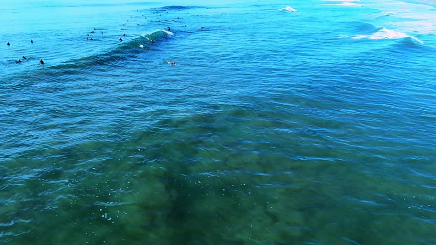 Exceptional viewpoint of breaking waves, surf, surfers, white sand beach and coastline of Huntington Beach.