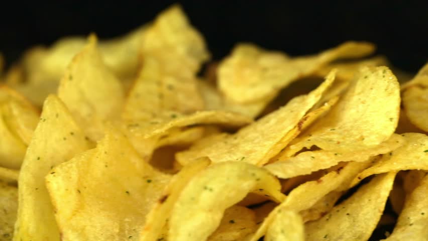 Potato chips on a dark background	 | Shutterstock HD Video #1098949385