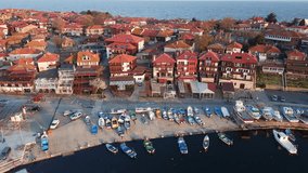 View from a height on the pier of the city - the islands of Pomorie with many boats and boats in the Black Sea