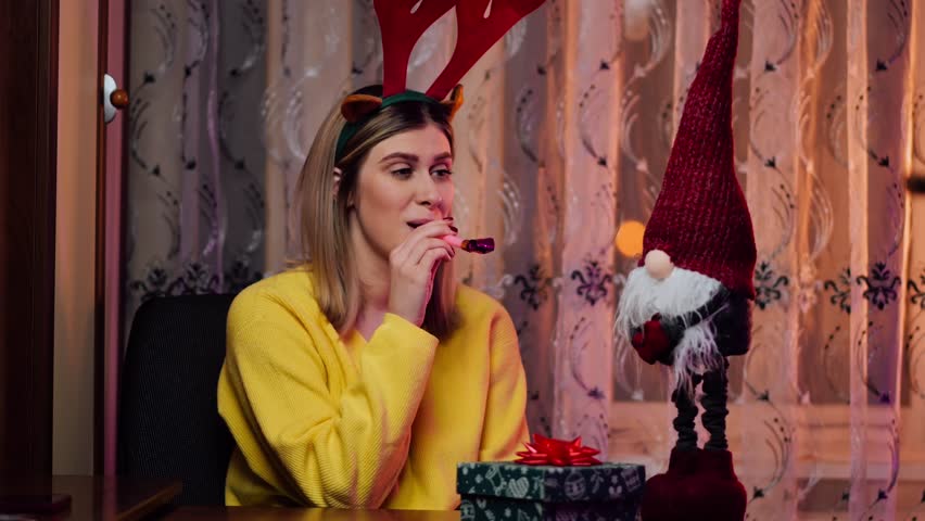 Unhappy girl feels sad and disappointed because no one came to celebrate anniversary, new year, blowing trumpet at party alone at home. People and holiday | Shutterstock HD Video #1098952129