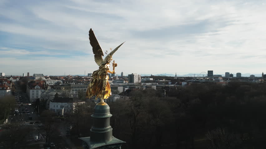 Aerial footage of picturesque European architecture against low-rise buildings. Iconic landmark of Friedensengel striking above clear, blue skyline. High quality 4k footage