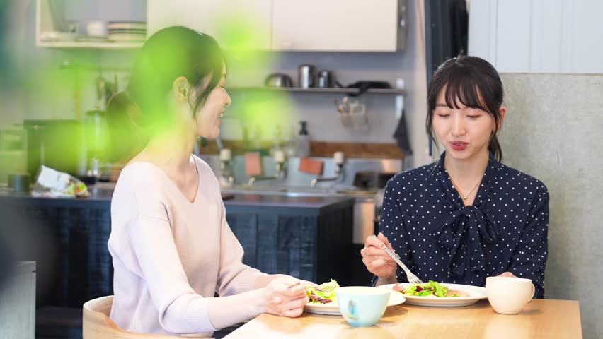 Two women chatting at a café Royalty-Free Stock Footage #1098961007