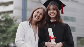 Happy Asian mother and graduated daughter take a picture in campus university together. - Powered by Shutterstock - Get 15% off with code: PIKWIZARD15
