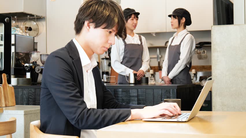 Young businessman working at a café