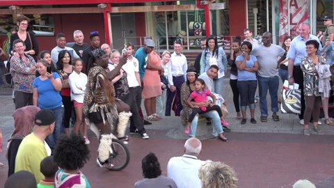 Cape Town, South Africa - March 2015: Busker performing in front of a crowd of people at Victoria and Alfred waterfront,Cape Town,South Africa