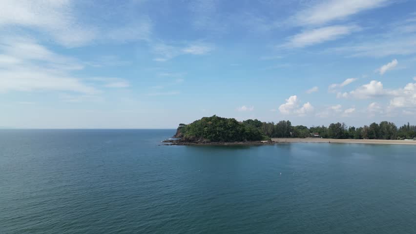 Aerial footage from a drone being flown in the ocean capturing the end of Kaw Kwang beach in Thailand. Footage was taken in the morning. December 2022.