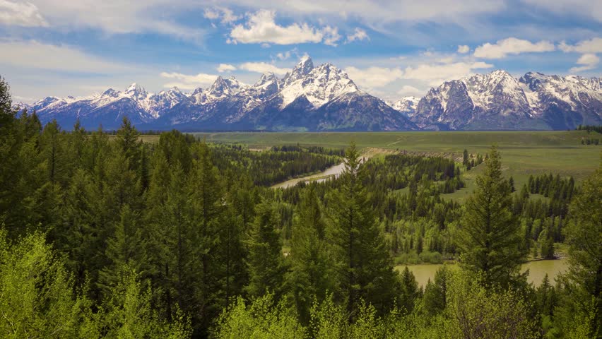 Pan right of Snake River and Grand Teton Mountains in Wyoming, USA. 4K UHD video.